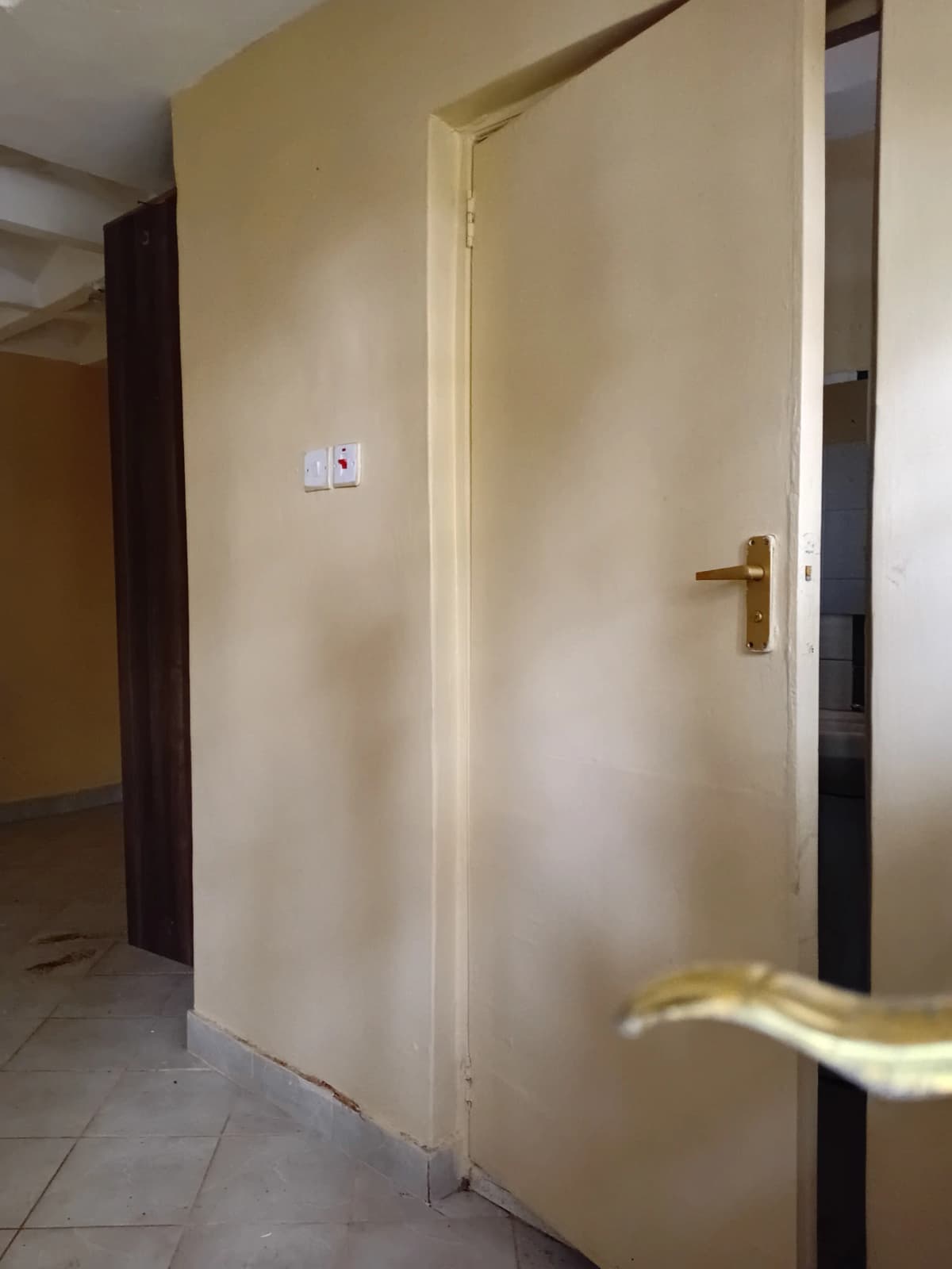 Hallway corridor with cream walls and doorways