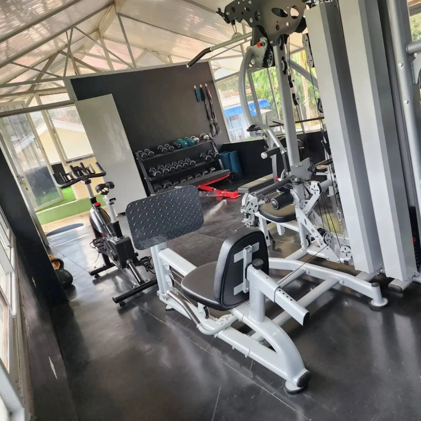 Home gym with cardio equipment and weight rack setup