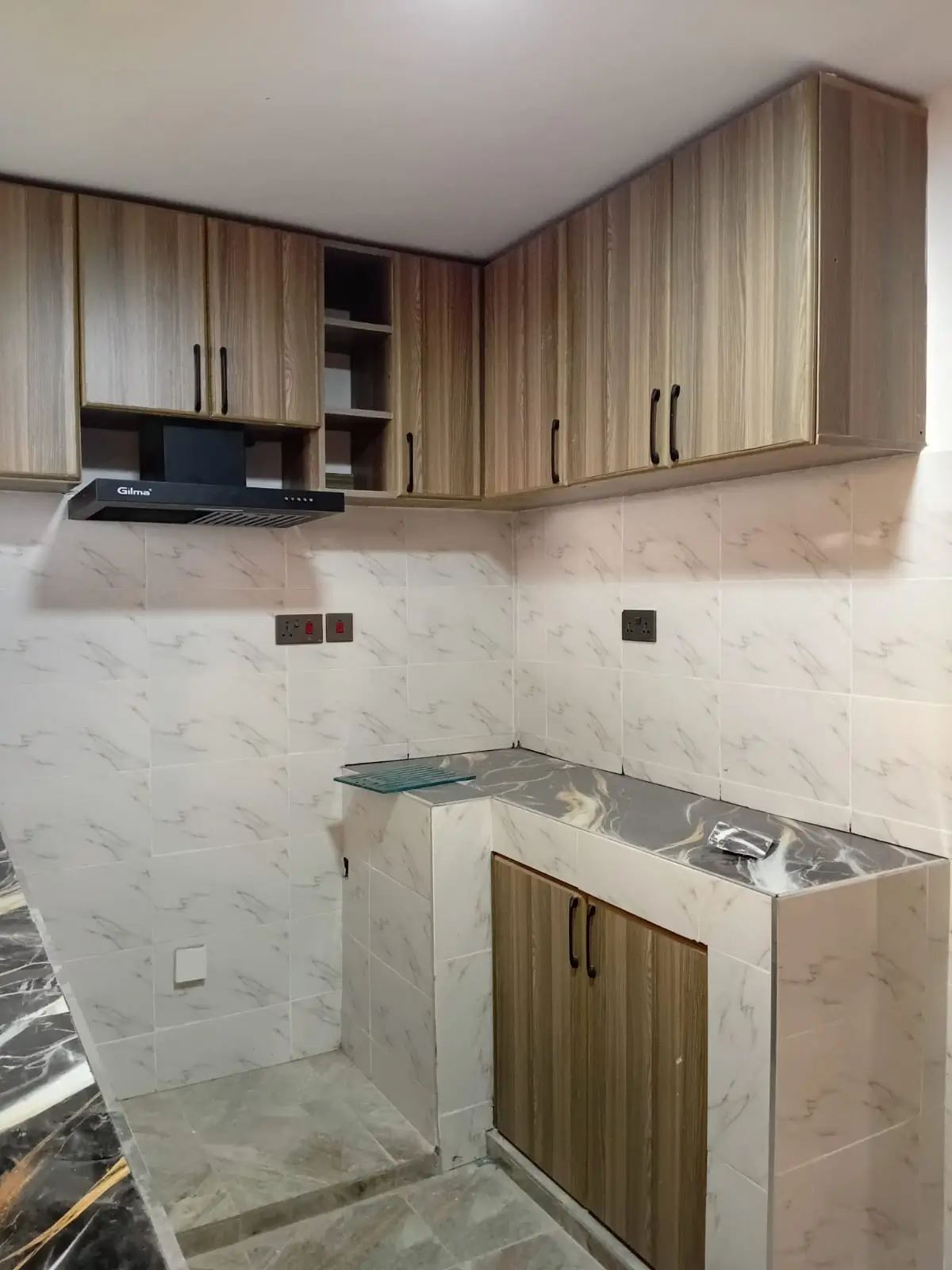 Modern kitchen with wooden cabinetry and marble backsplash