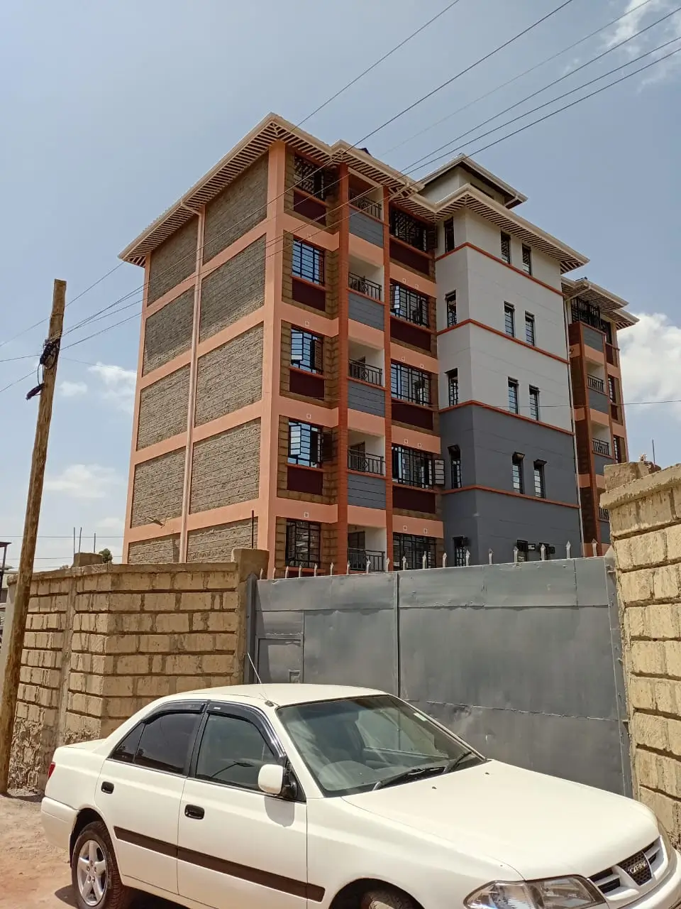 Multi-story residential building with stone and brick facade
