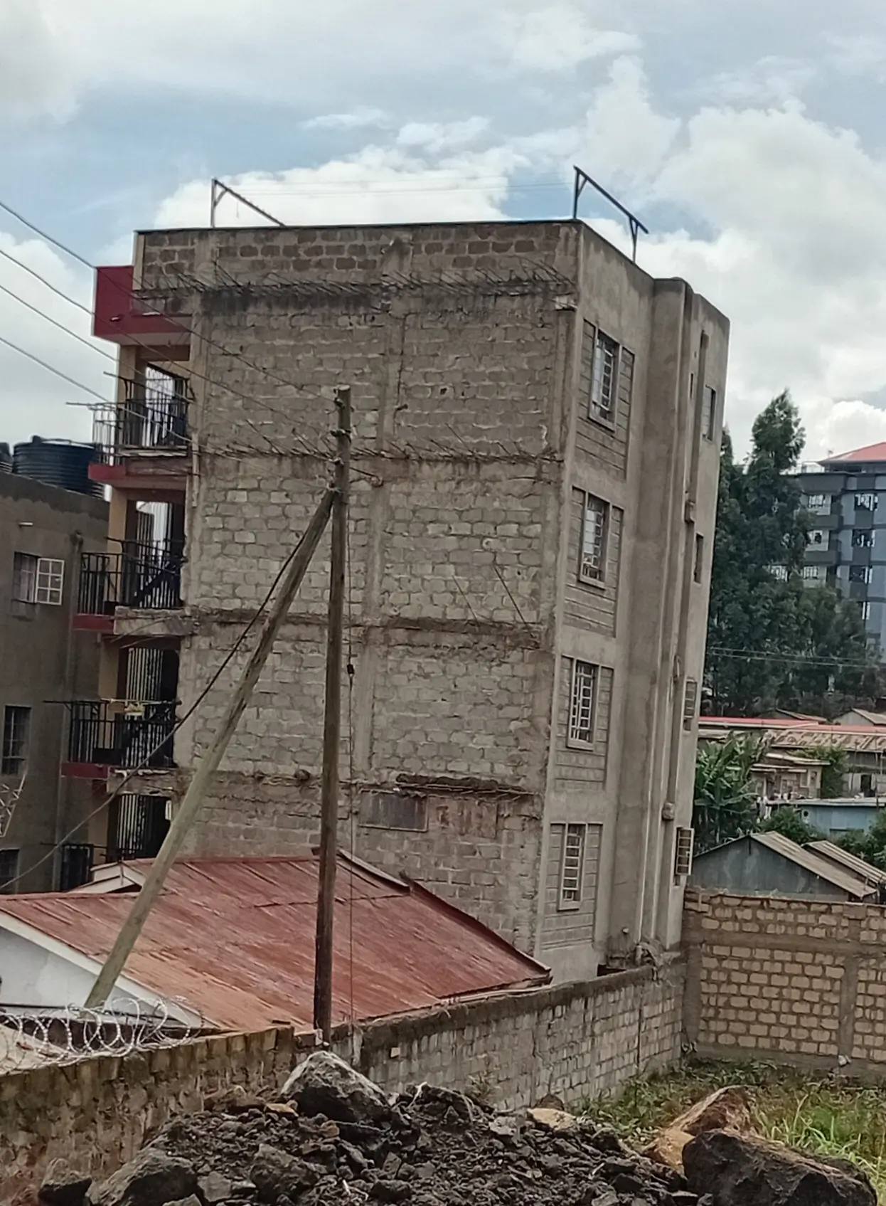 Multi-story residential building facade with adjacent rooftop