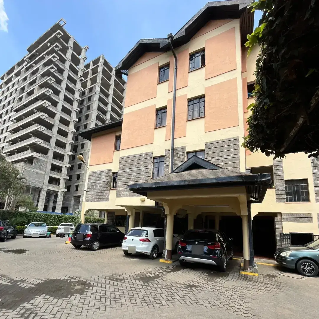 Covered parking bay with modern residential building facade