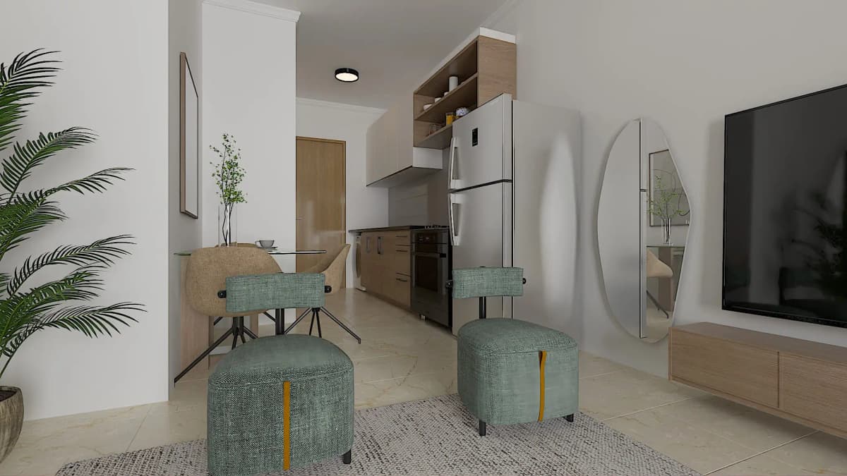 Open-plan living area with green chairs and kitchen beyond