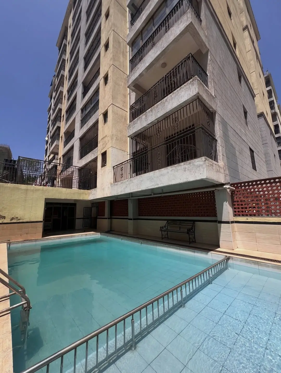 Residential building compound pool with surrounding deck area