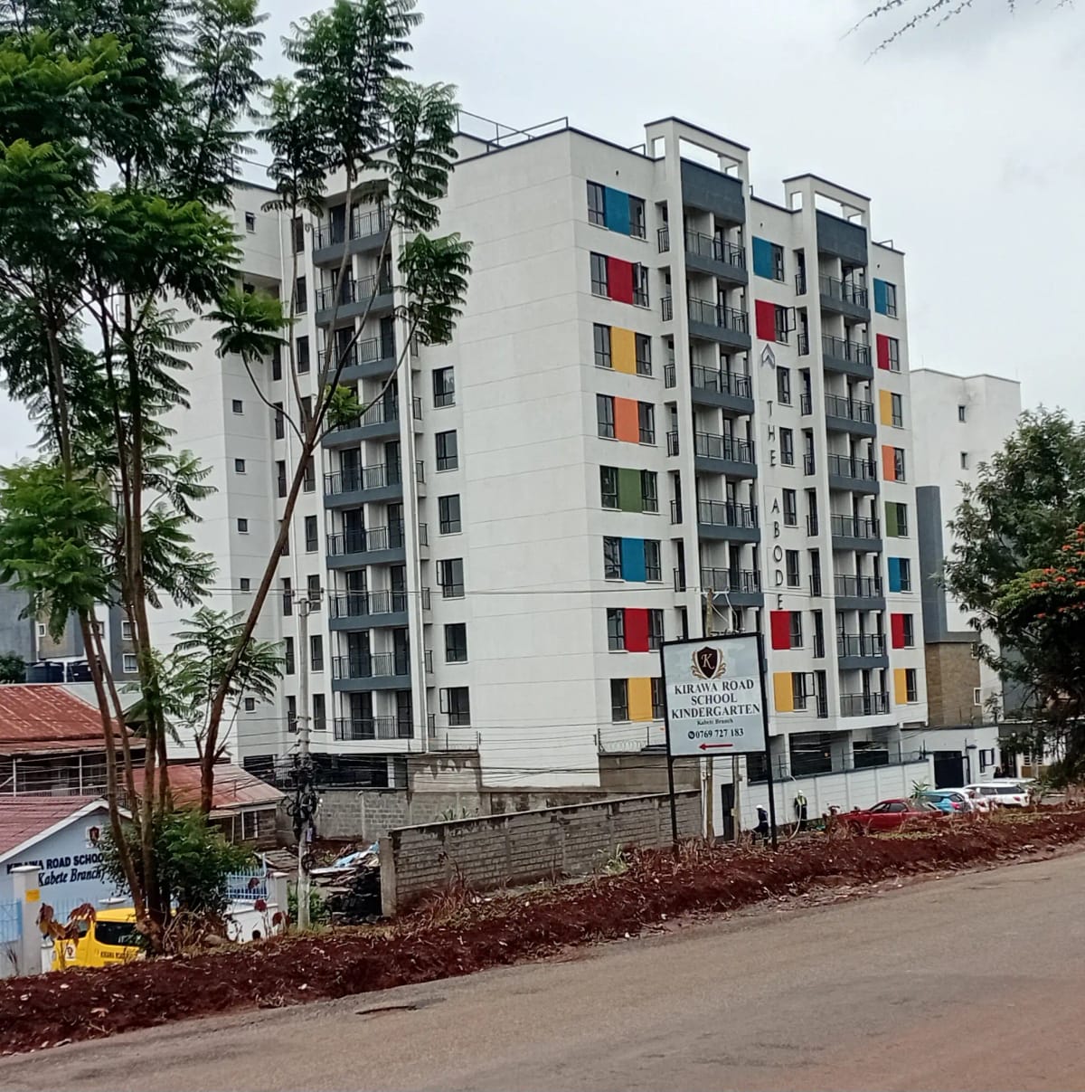 Modern multi-story residential building facade with colorful balconies