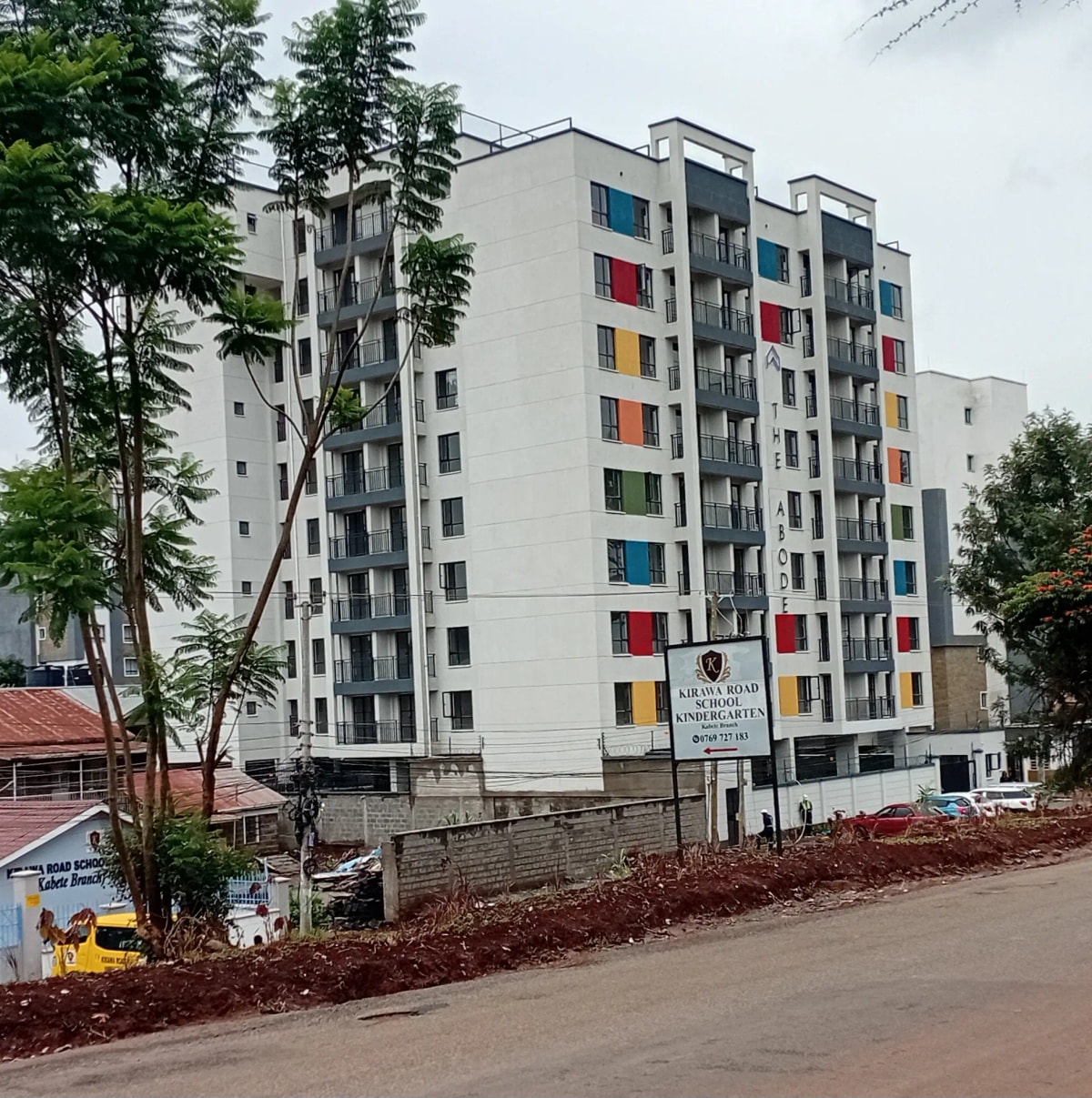 Modern multi-story residential building facade with colorful balconies