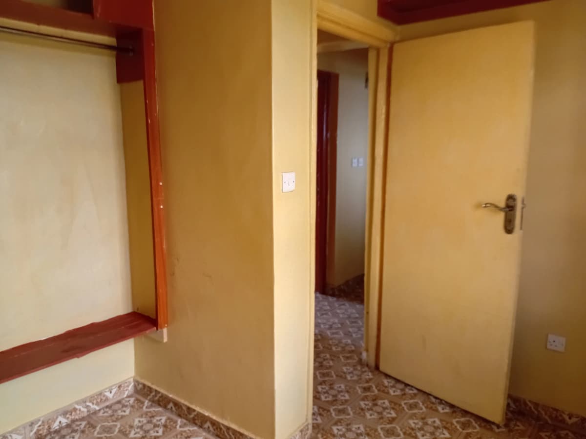 Corridor with yellow walls, multiple doors, patterned flooring
