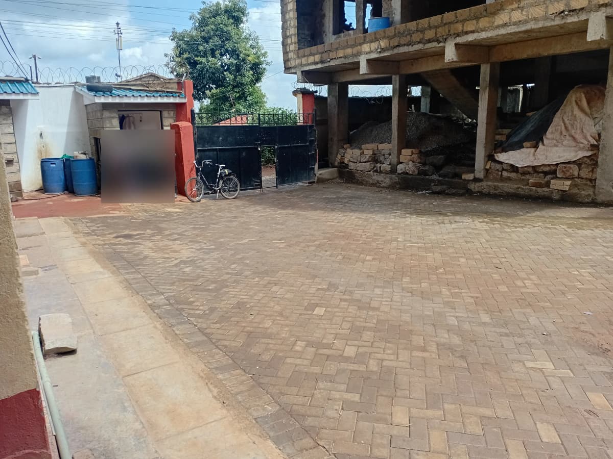 Paved compound with underbuilding and utility storage area